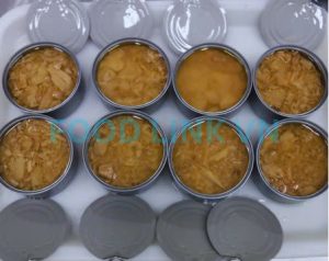 Final quality inspection of canned tuna after sealing